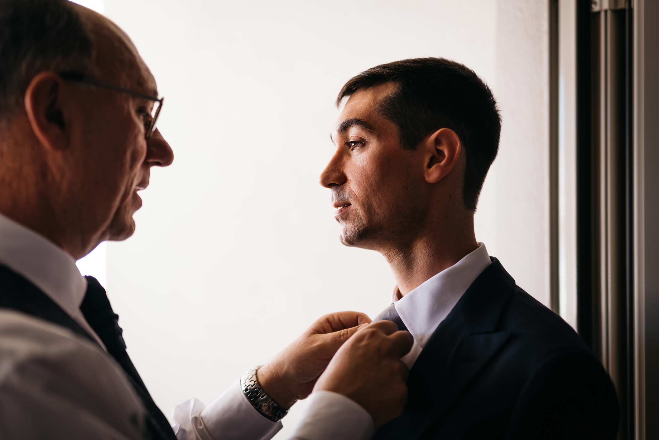 Groom preparation with his father, wedding reportage